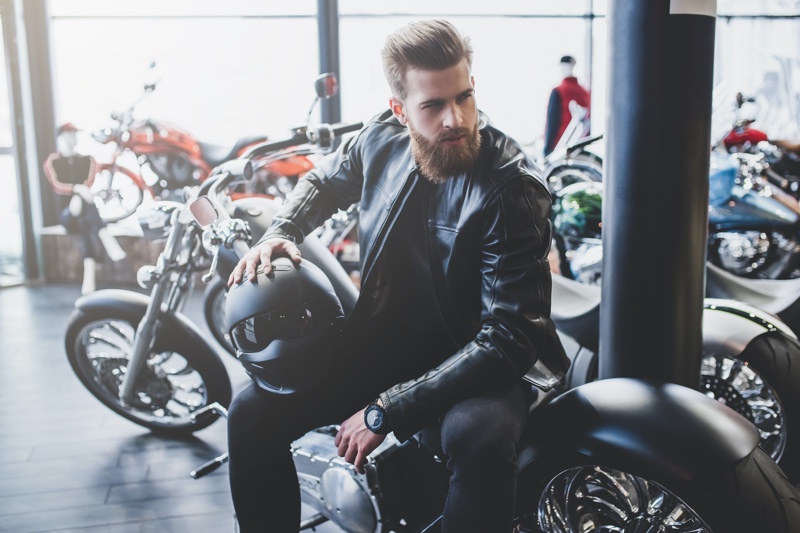 Male Model Motorcycle Shop Holding Helmet Leather Jacket
