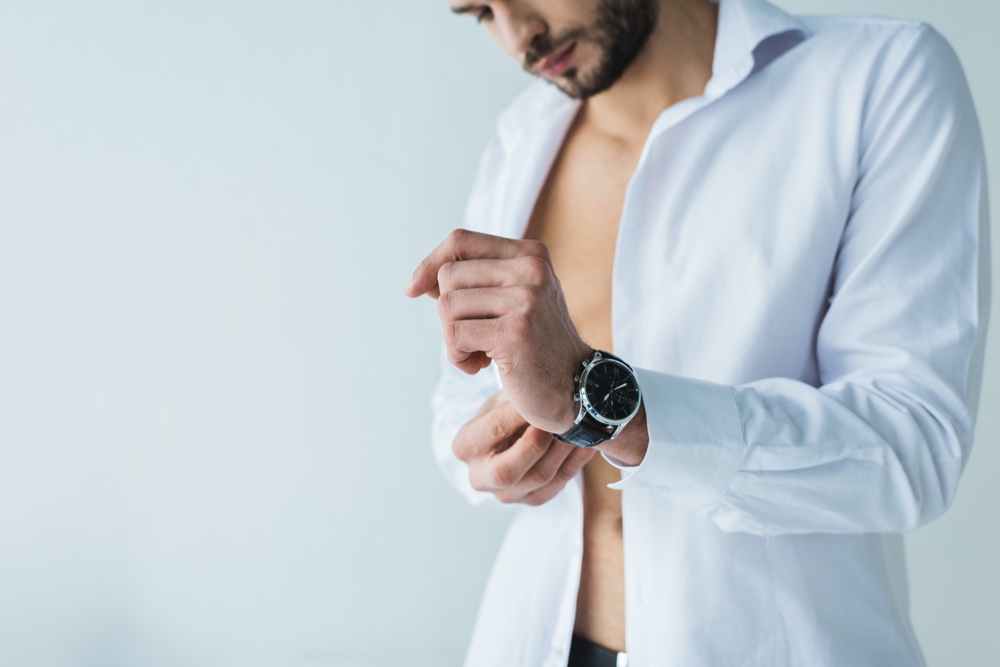 Man Putting on Watch Open Shirt