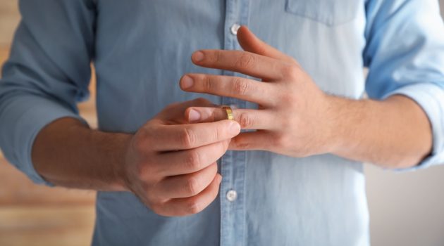 Why You Need to Buy Jewelry Insurance Man Taking Off Wedding Band