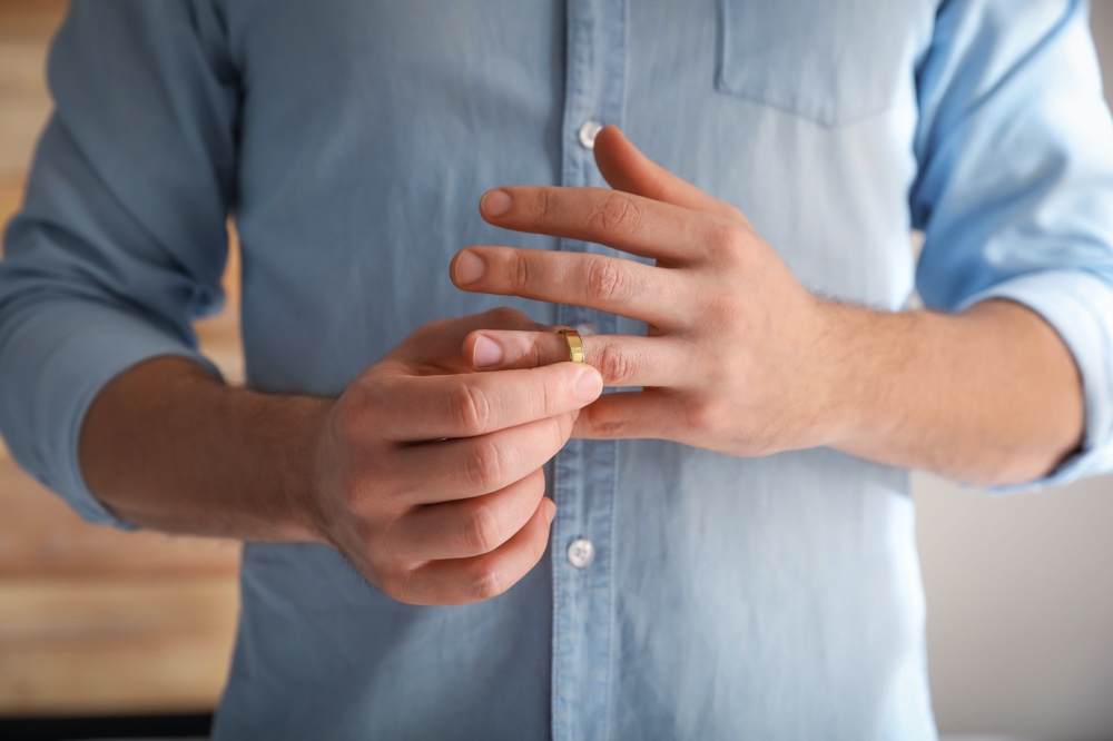 Man Taking Off Wedding Band Man Taking Off Wedding Band