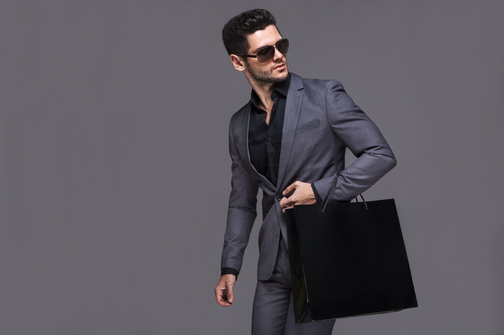 Man in Suit Sunglasses with Shopping Bag