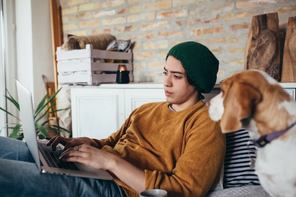 Man on Laptop with Dog