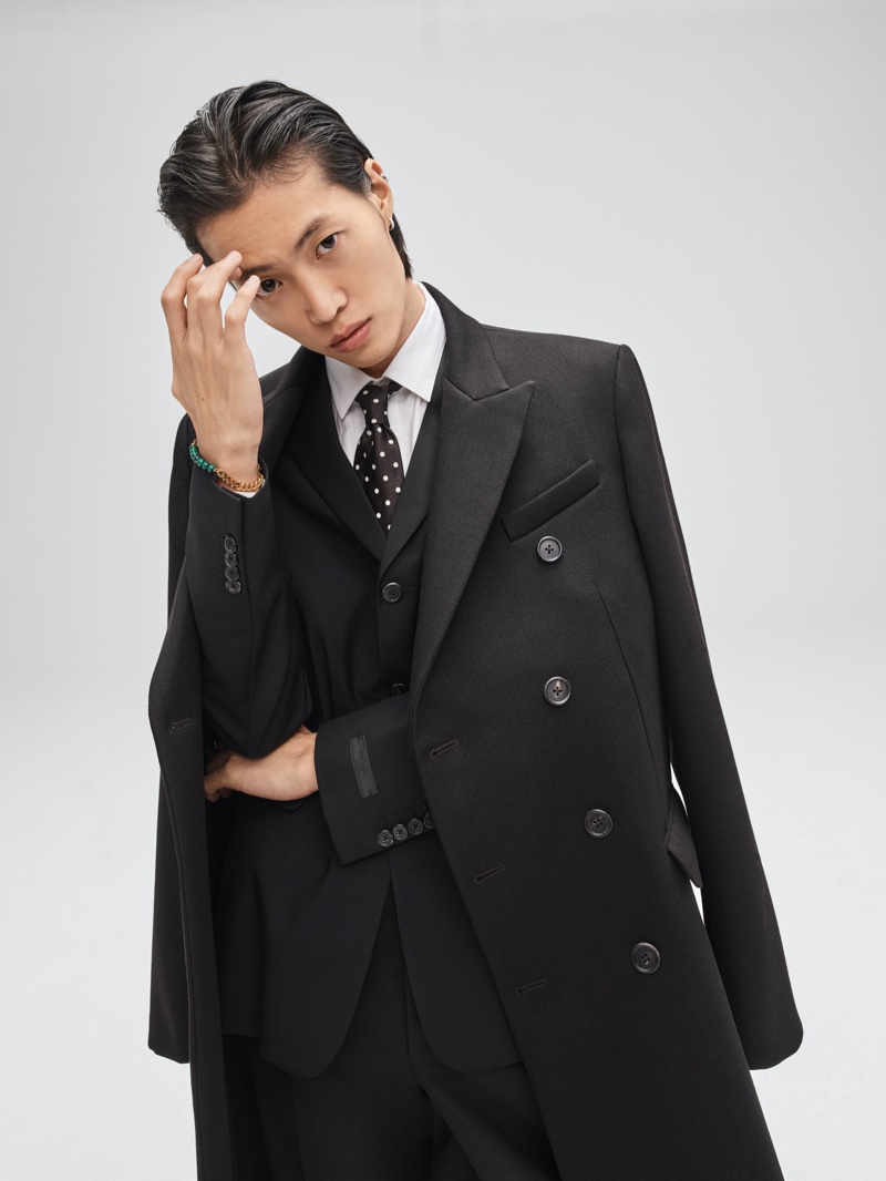 Ungho Go gets sartorial in a neatly fitted suit and coat for Mytheresa's 2021 festive campaign.