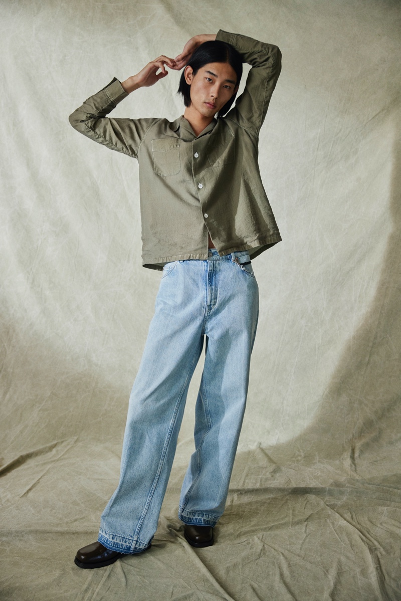 Rocking a Cuban-collared shirt and light wash jeans, Taemin Park wears a look from the Our Legacy x Mytheresa capsule collection.