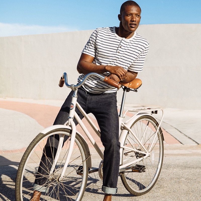 Model Festus Amarteifio dons dark wash denim jeans from Peluro.