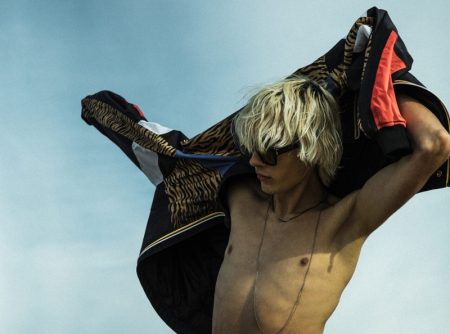 Heading to the beach, Rocco Segers wears a K-Way bomber with a tiger print from Saint Laurent's Rive Droite line.