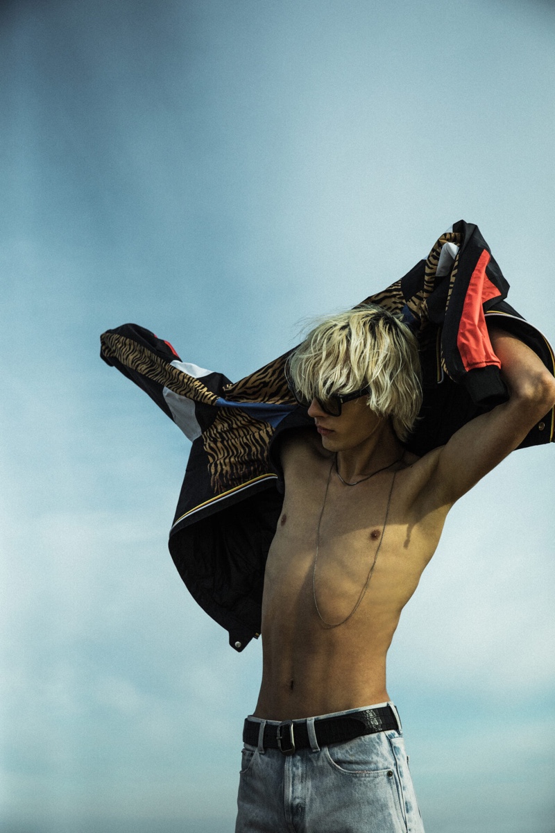 Heading to the beach, Rocco Segers wears a K-Way bomber with a tiger print from Saint Laurent's Rive Droite line.