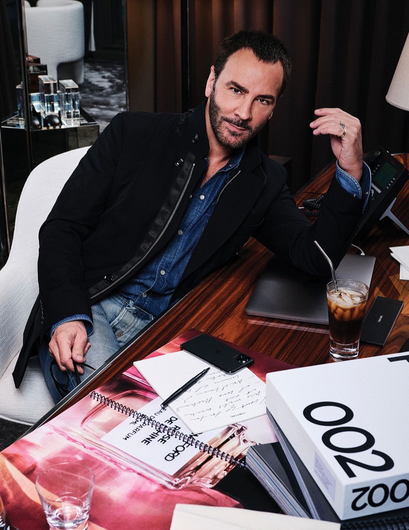 Designer Tom Ford poses at his desk for a photo.