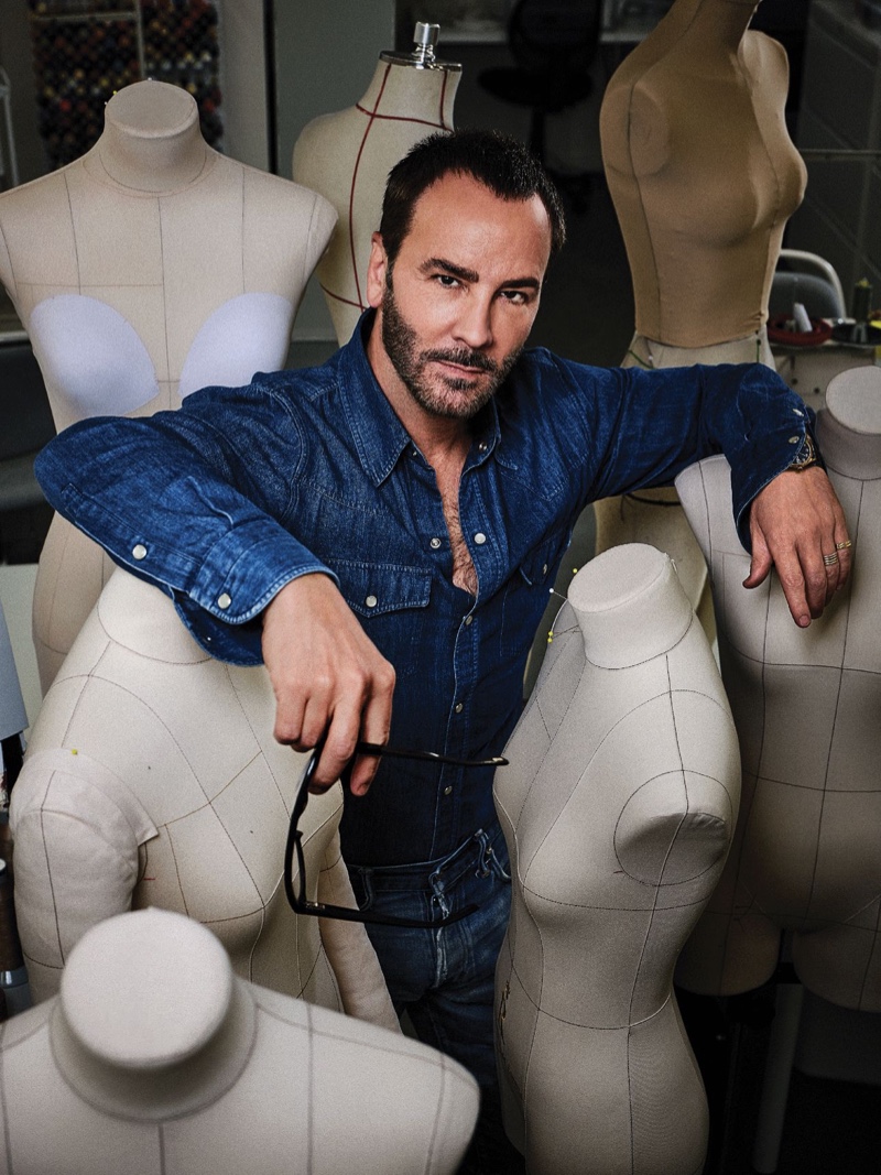 Tom Ford sports double denim as he poses amongst dress forms. 