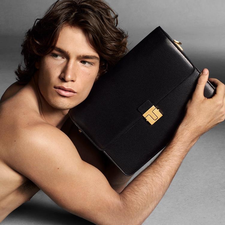 Lander Dalton takes hold of a black bag for Tom Ford's fall-winter 2021 campaign.
