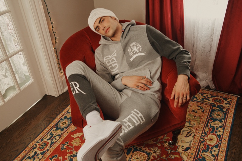 Charlie Knepper sports a matching hoodie and joggers for Tommy Hilfiger's holiday 2021 campaign.