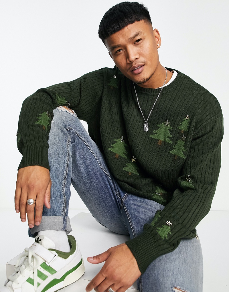 Zak Srakaew sports Christmas tree print sweater from ASOS.