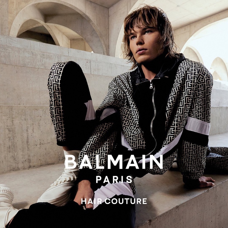 Jordan Barrett sports a black and white tracksuit as the star of the Balmain Paris Hair Couture fall-winter 2021 campaign.