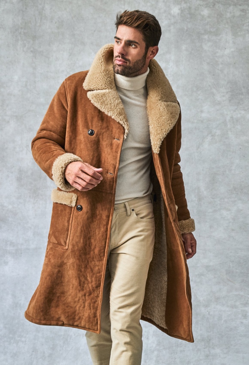 Winter arrives with stylish new options from Todd Snyder. Here, Chad White models the brand's Italian shearling collar double-breasted coat with a cashmere turtleneck and slim-fit 5-pocket chinos.