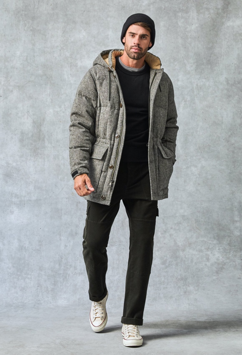 Staying warm, Chad White dons a Todd Snyder English down parka with Italian brushed twill cargo pants, a cashmere crewneck, and Italian recycled cashmere beanie.