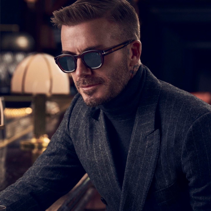 Embracing tailoring in a pinstripe suit, David Beckham wears DB 7062/S sunglasses.