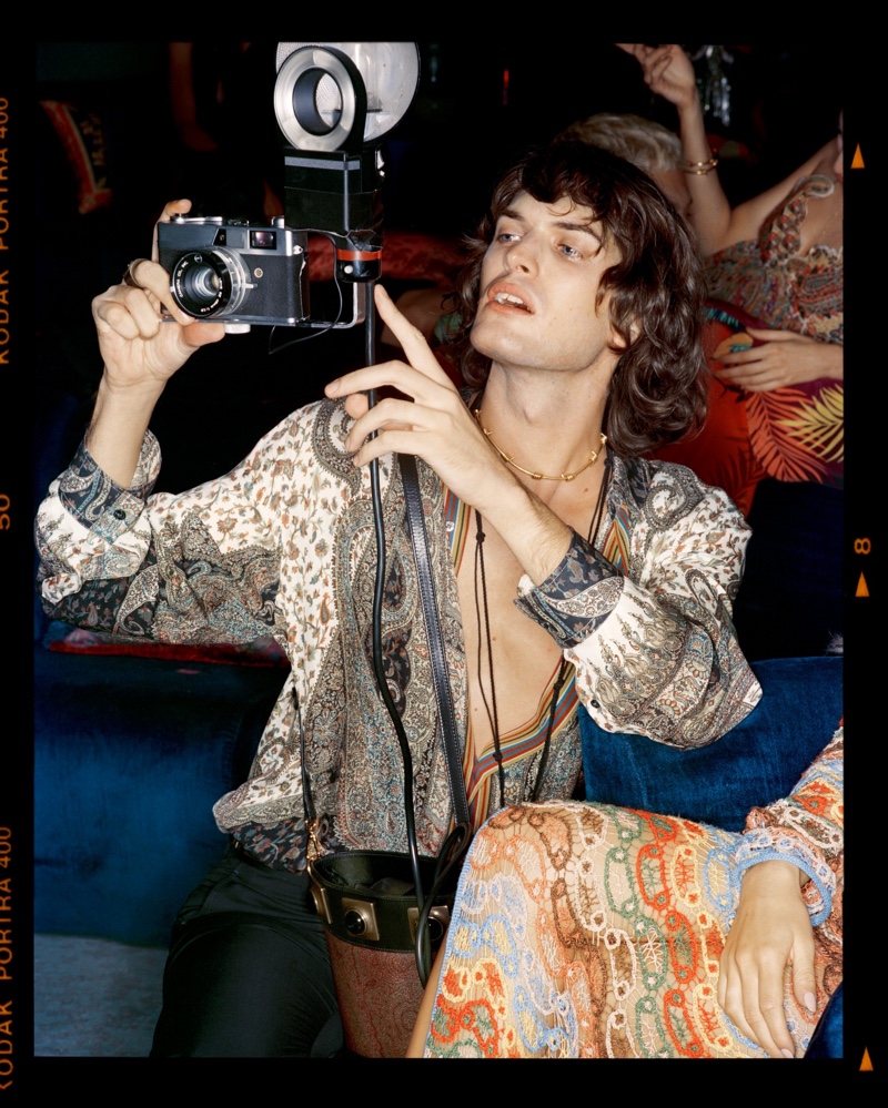 Lorenzo Sutto is pictured snapping a photo for Etro's holiday 2021 campaign.