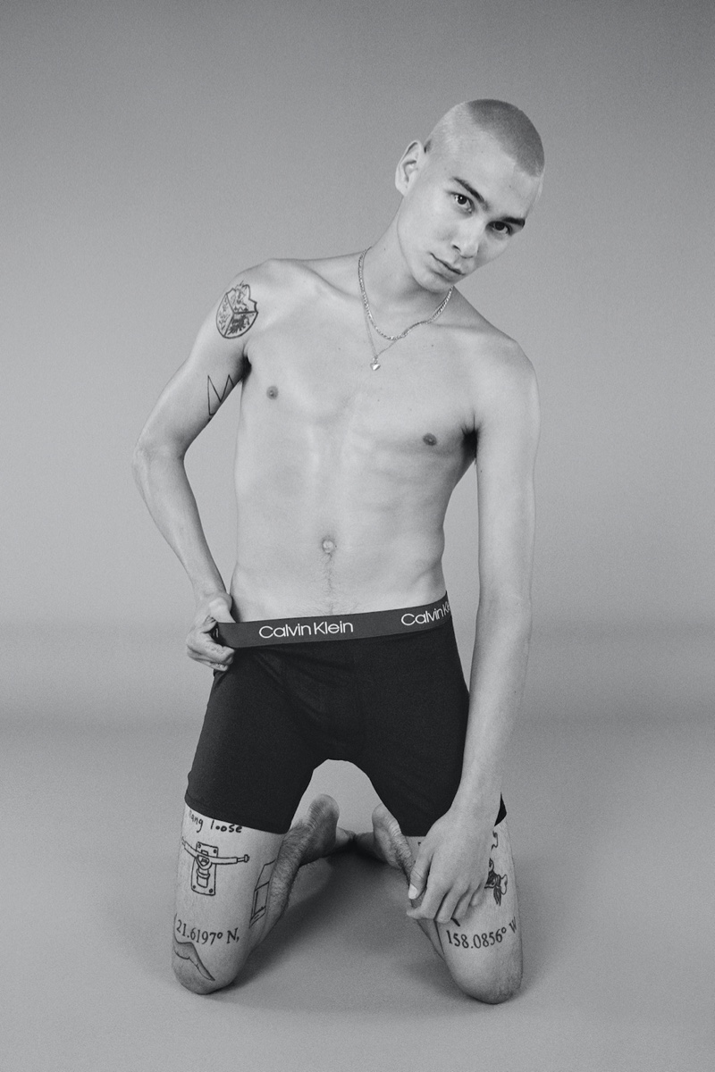 Appearing in a black and white photo, Evan Mock stars in Calvin Klein's holiday 2021 campaign.