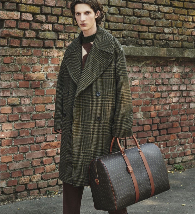 Embracing the oversized trend, Hugo Gillain rocks a Dries Van Noten double-breasted wool coat for Mytheresa.