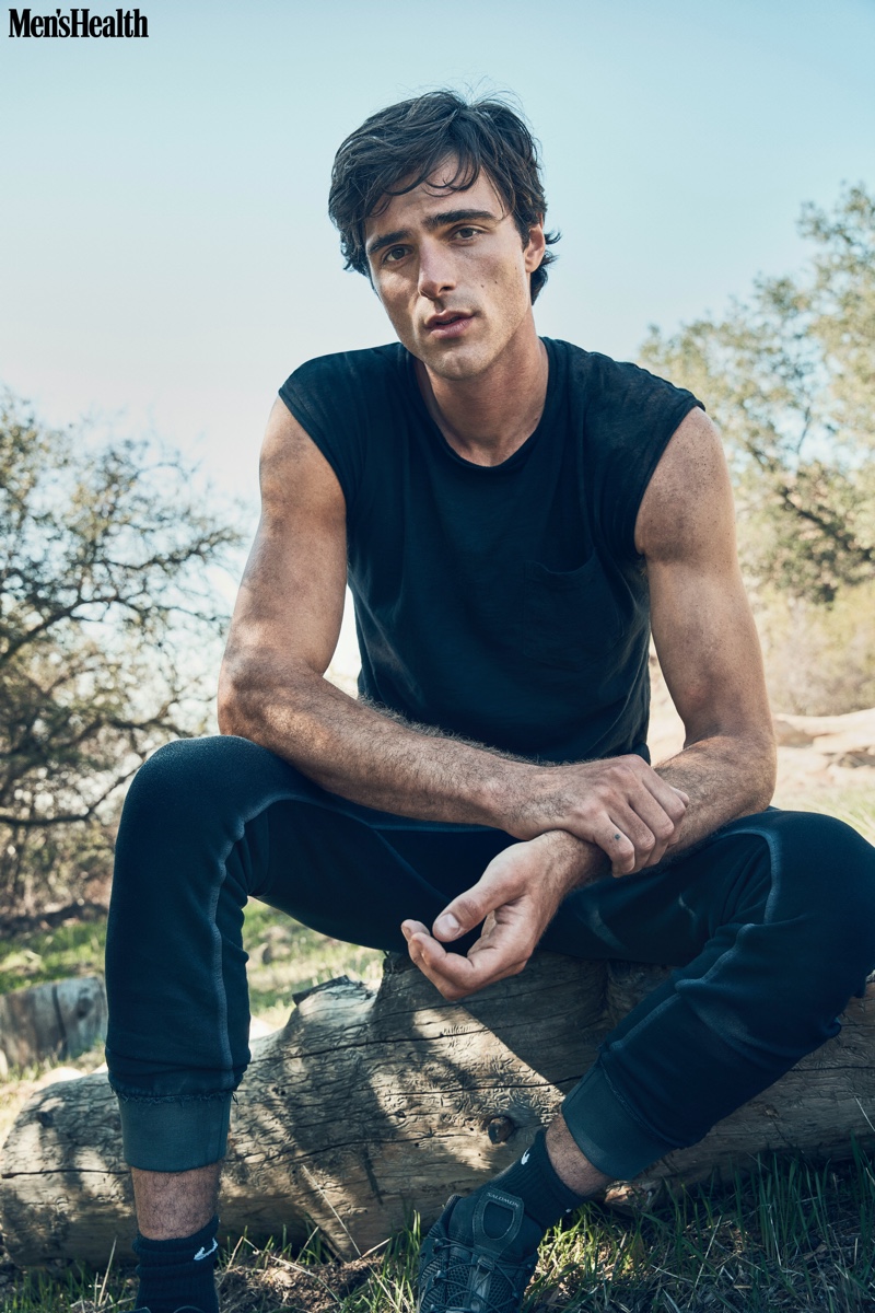 Dressed in black, Jacob Elordi wears a Hiro Clark tank, Cotton Citizen joggers, Nike socks, and Salomon sneakers.