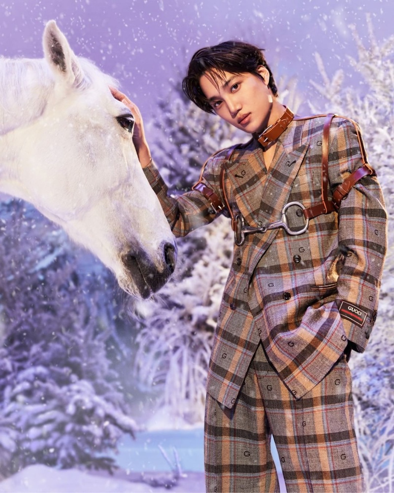 Petting a horse, Kai dons a plaid Gucci Aria suit with a leather harness for the brand's holiday 2021 campaign.