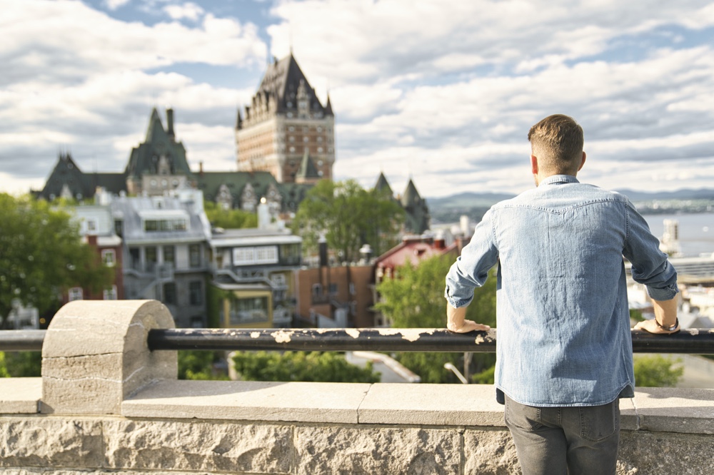 Man Looking at Chateau Frontenac in Canada Man Looking at Chateau Frontenac in Canada