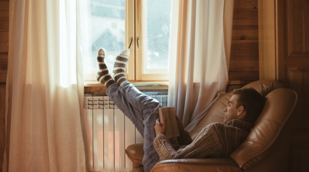 7 Tips to Make Your Home Cozy This Winter Man Relaxing at Home Indoors Cozy