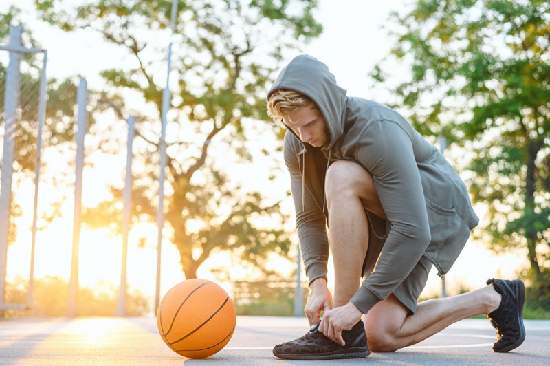 Man Tying Basketball Sneakers