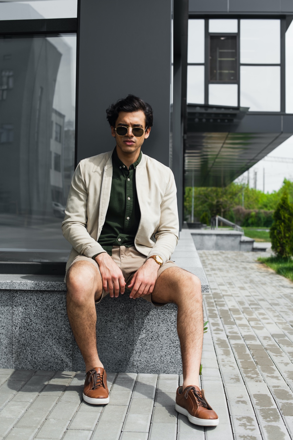 Man Wearing Bomber Jacket and Shorts