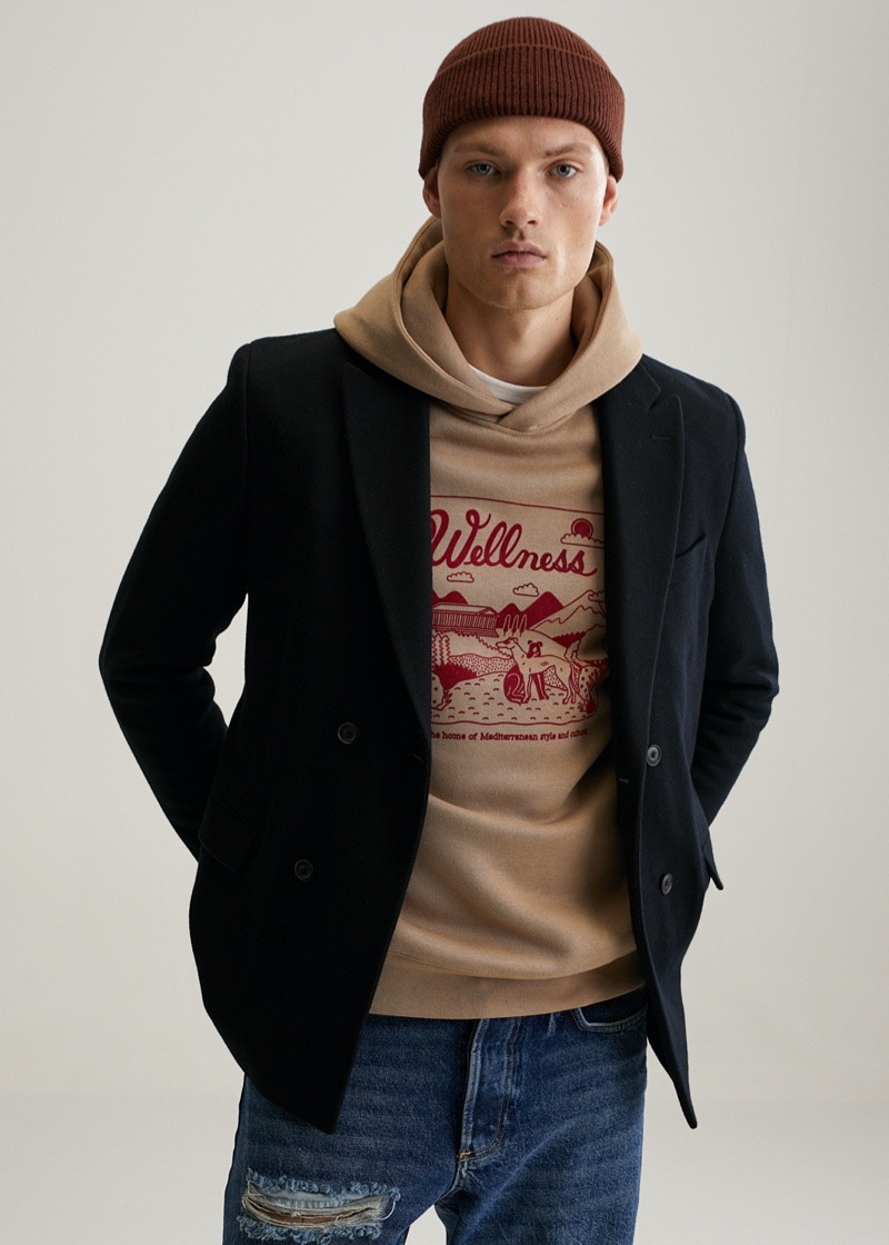 Model William Los layers a hoodie from the Tiago Majuelos x Mango capsule collection with a smart double-breasted blazer.