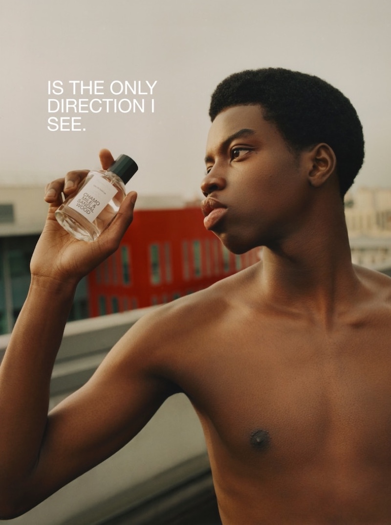 Model and dancer Cédric Sanvee poses with a bottle of Massimo Dutti's chamomile and sandalwood fragrance.