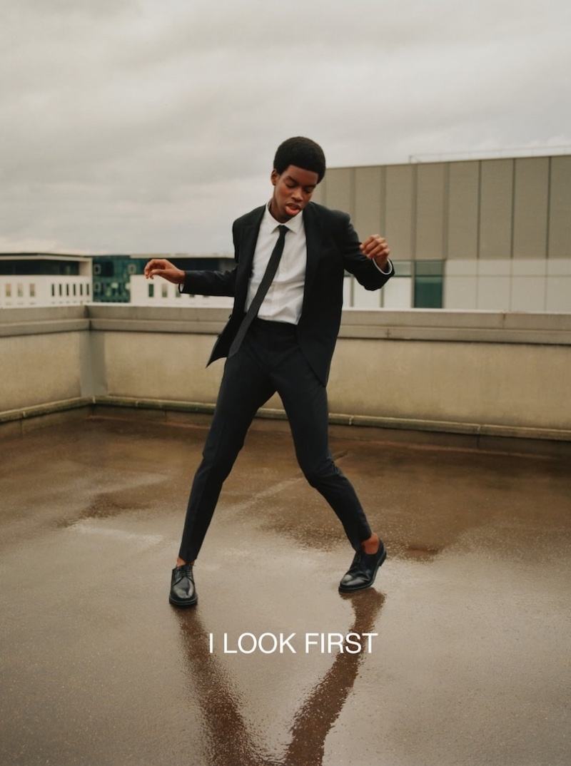 Donning a trim black suit with a shirt and skinny tie, Cédric Sanvee fronts one of Massimo Dutti's latest outings.