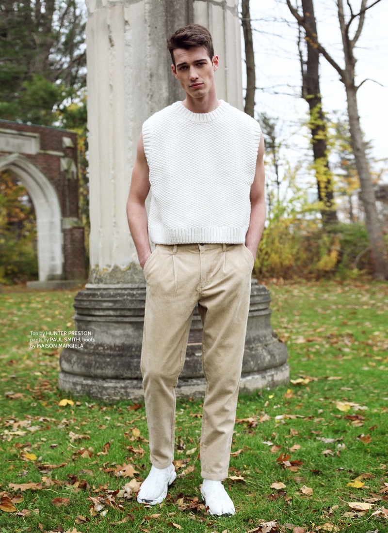 Robbie wears sweater vest Hunter Preston, pants Paul Smith, and boots Maison Margiela.