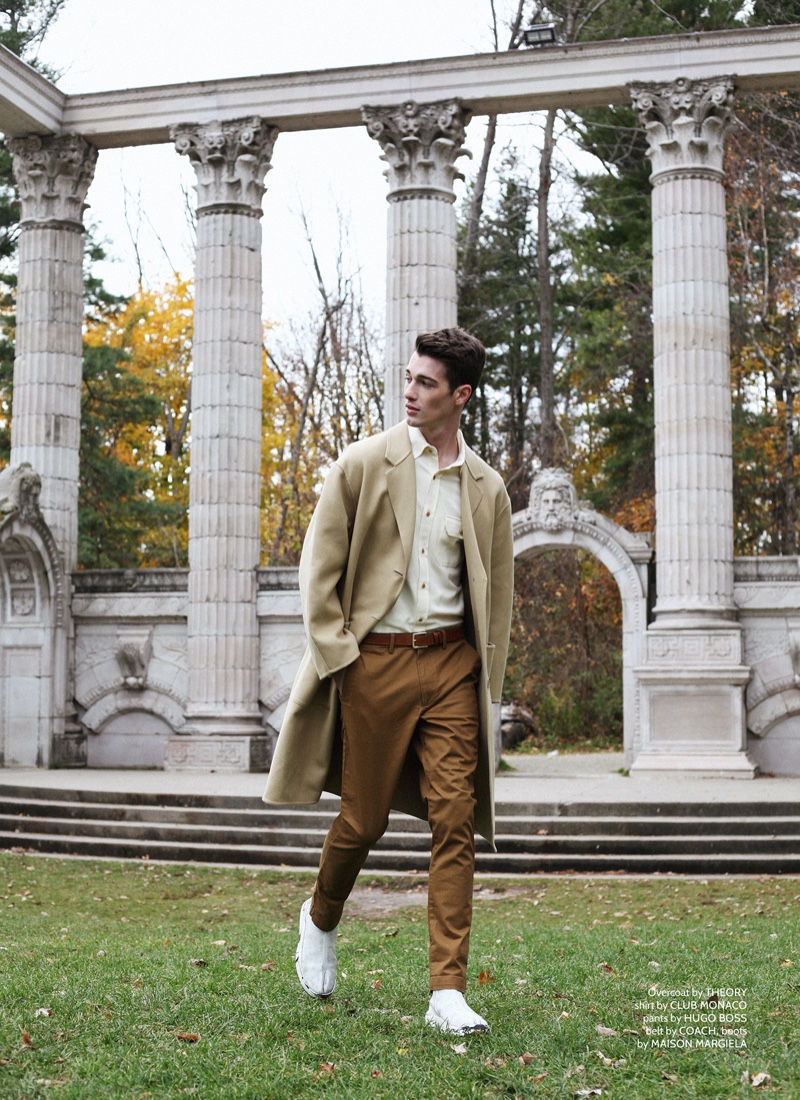 Robbie wears coat Theory, shirt Club Monaco, pants Hugo Boss, belt Coach, and boots Maison Margiela.