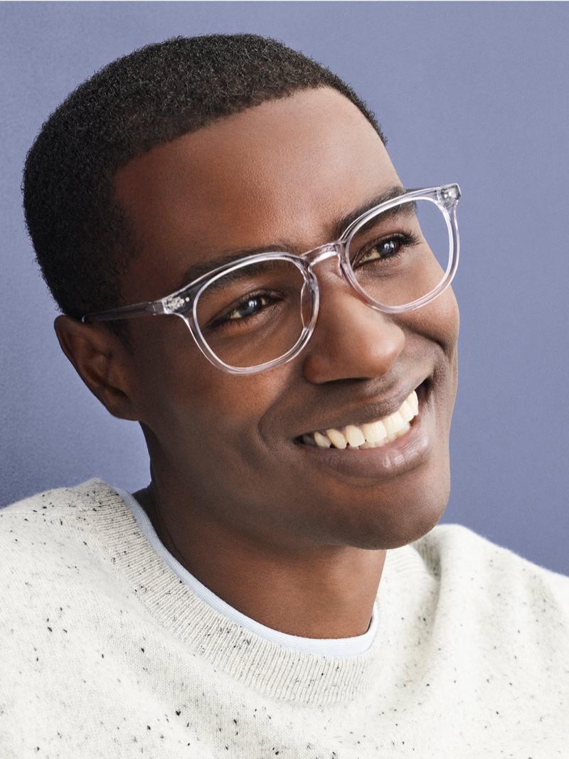 All smiles, Narada Wesonga makes a clear statement in Warby Parker's Carlton glasses in crystal.