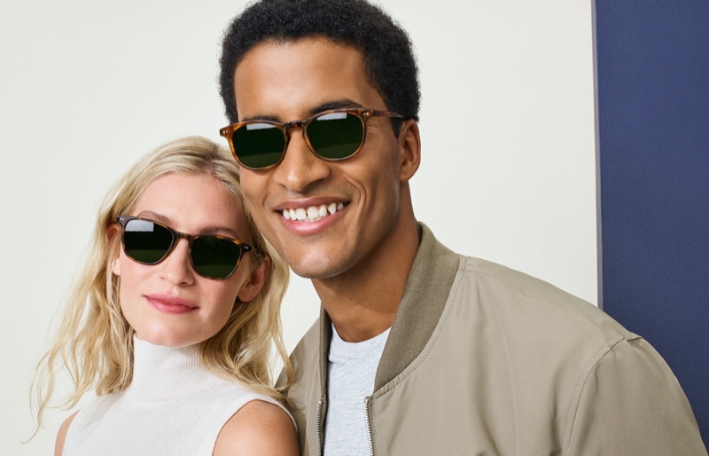 Pictured right, Adom wears Warby Parker's Malik glasses in Maple Tortoise, opposite the brand's Dawson eyewear in Oak Barrel.