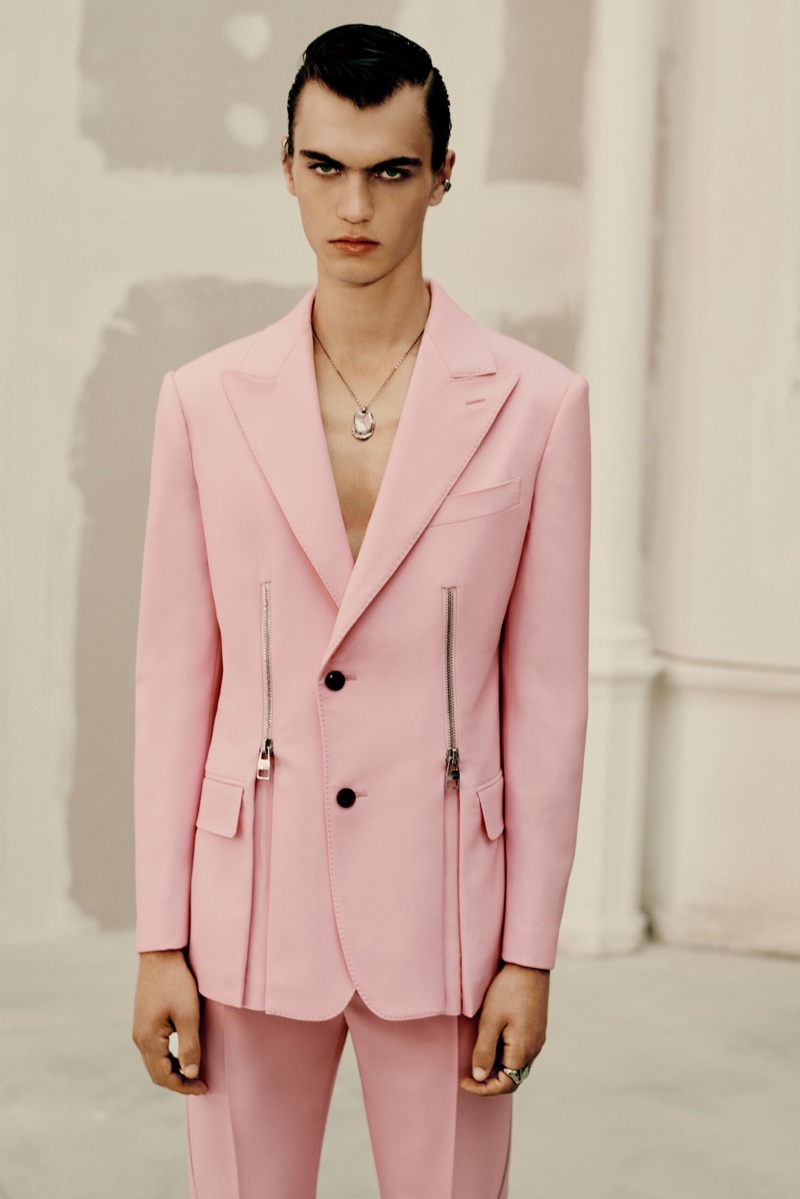 Donning a pink suit, Lars Jammaers appears in Alexander McQueen's spring-summer 2022 men's campaign.
