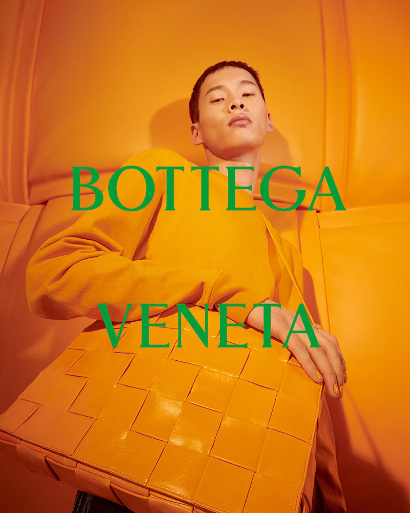 Donning tangerine fashions, Wang Chenming fronts Bottega Veneta's 2022 Chinese New Year campaign.