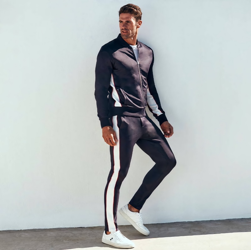 Championing sporty style, Chad White rocks a Ron Dorff tracksuit.