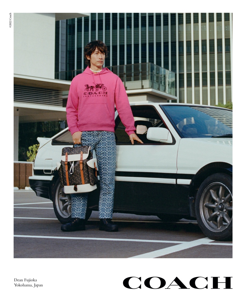 Sporting a pink hoodie, Dean Fujioka stars in Coach's spring-summer 2022 campaign.
