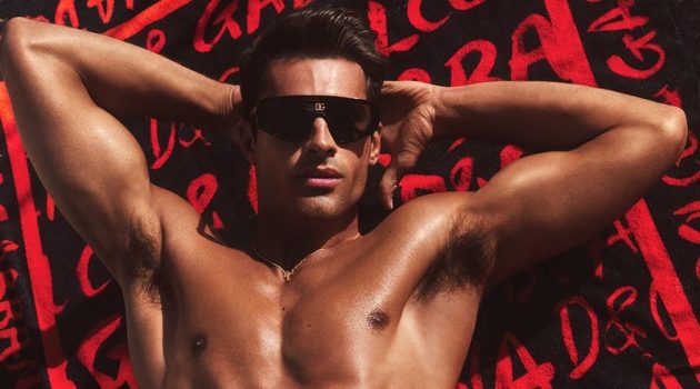 The Season Heats Up with Dolce & Gabbana Beachwear Campaign Elliot Meeten dons a red and black Dolce & Gabbana print swimsuit for the Italian brand's 2022 beachwear campaign.