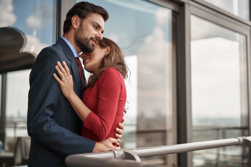 Engaged Couple Embracing Man Suit