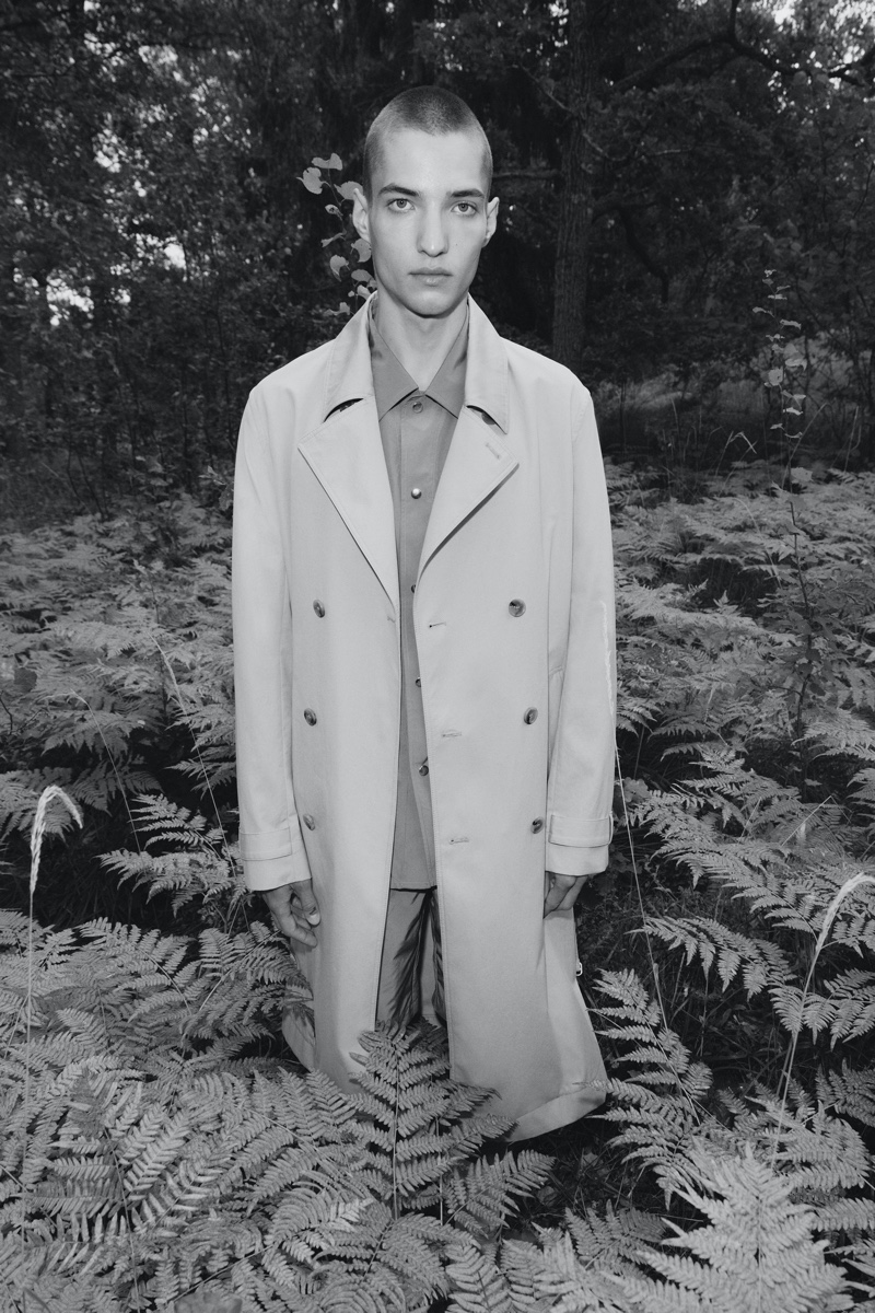 Sporting a relaxed trench, Davyd Shyn stars in Filippa K's spring-summer 2022 men's campaign.