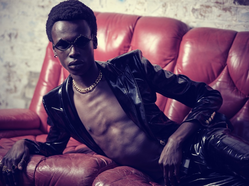 Reclining, Emmanuel Adjaye models a leather suit from Helen Anthony.