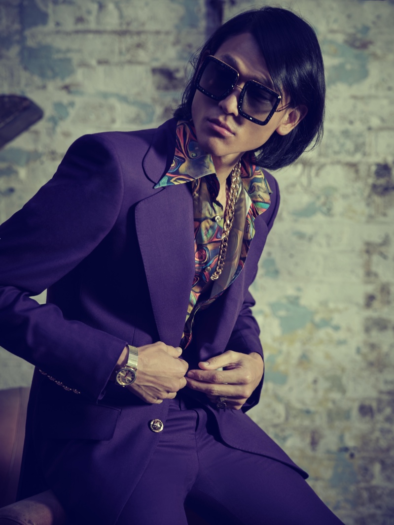 Sporting Anna-Karin Karlsson sunglasses, Sheldon Chang is a striking vision in a purple suit and printed shirt from Helen Anthony.