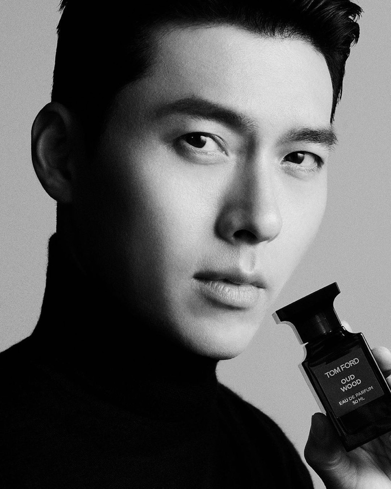 Actor Hyun Bin appears in a black-and-white image for Tom Ford Oud Wood Eau de Parfum.