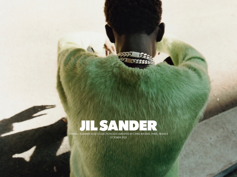 Photographed from the back, Moustapha Sy appears in Jil Sander's spring-summer 2022 campaign.