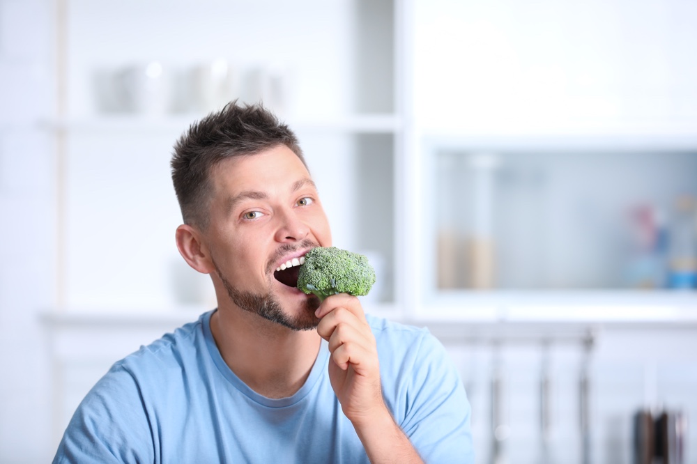Man Eating Broccoli Vegetables