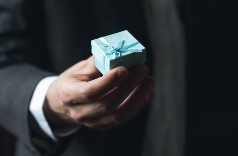 Man Holding Blue Box Engagement Ring