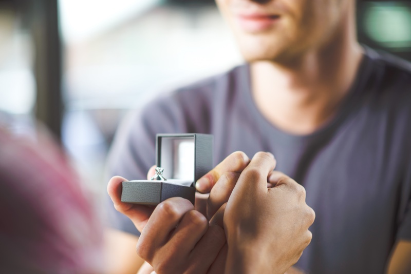 Man Holding Engagement Ring Box